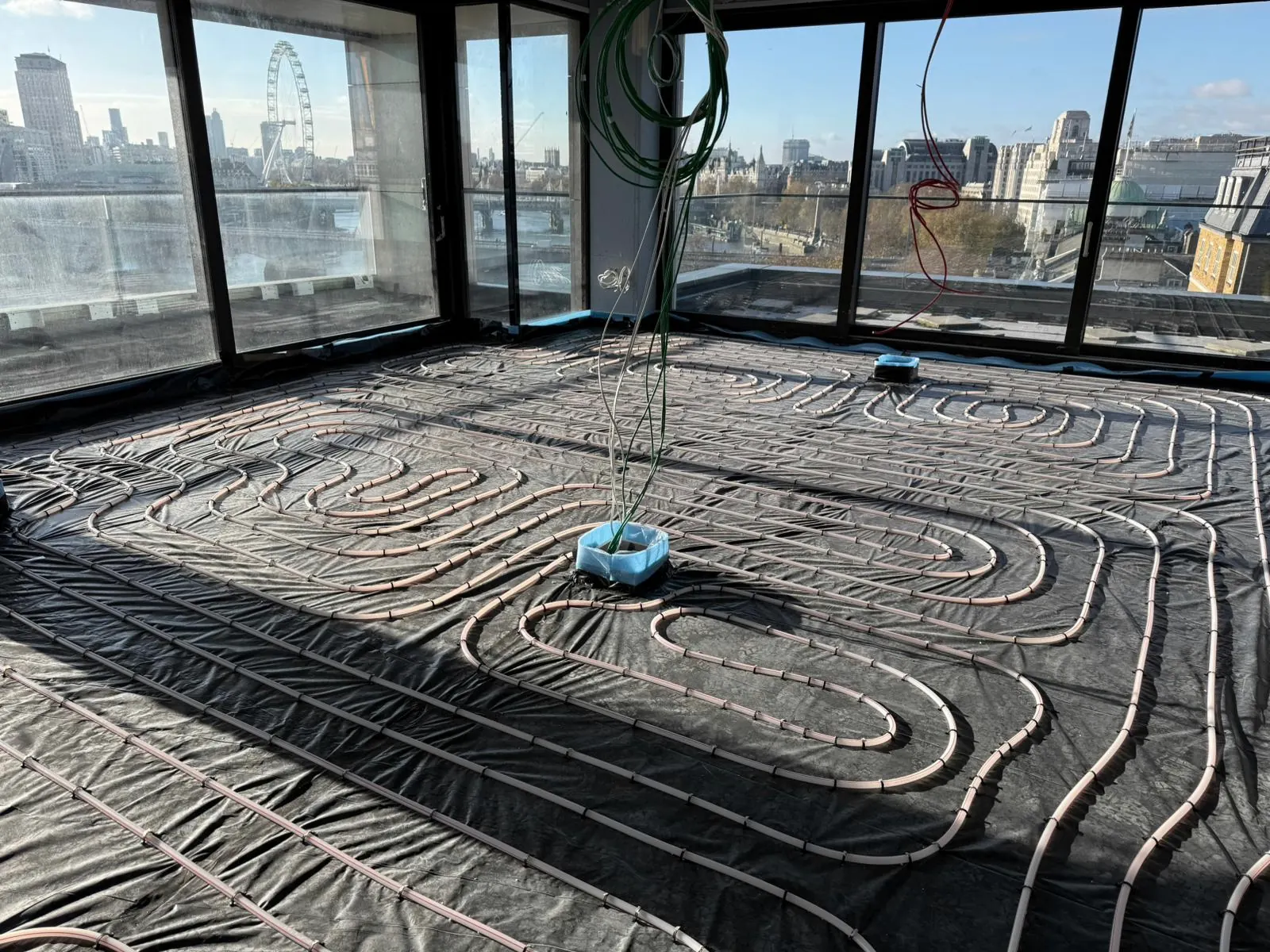 Underfloor heating pipework laid out ready for screed in a riverside apartment